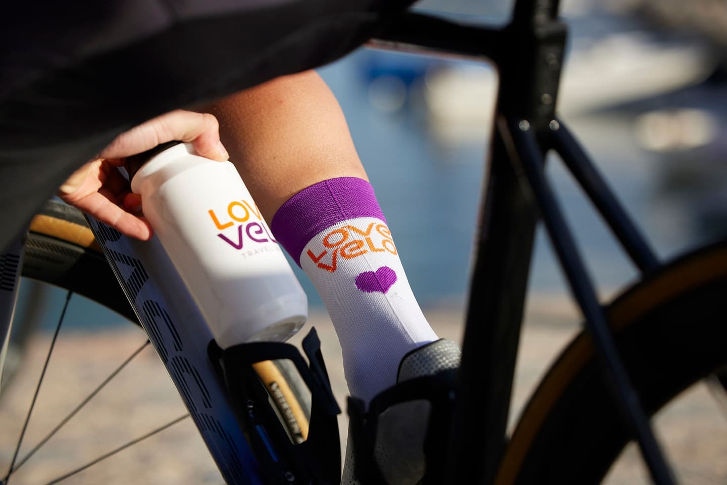 Close up of cyclist's hand picking up bottle from bottle cage