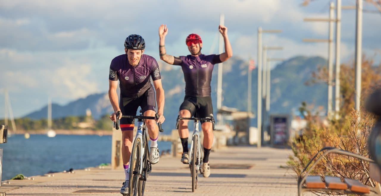 Cyclists riding on a scenic seaside path.